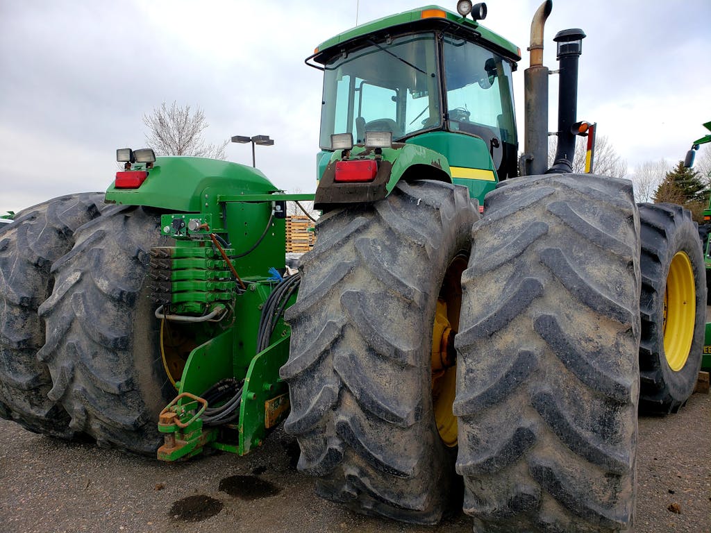 Massive green tractor with large tires suited for heavy-duty agricultural work.